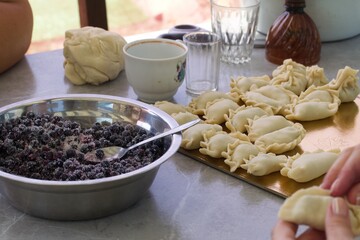 Blueberries for dumplings. Sprinkled with sugar. Close by are the sticky dumplings. Close-up.