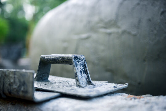 Close-up Buttering Trowel construction equipment for building the house with sunlight, Concept Construction