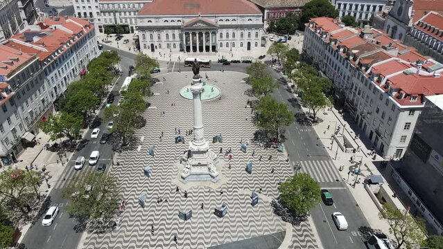 A drone camera flies forward over the Dom Pedro IV Square in Lisbon, Portugal