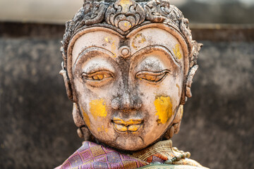 Vintage Stone Traditional Statue in Woman Character at backside of Wat Phra That Chom Kitti, a worship place at Chiang Rai, Thailand. - obrazy, fototapety, plakaty