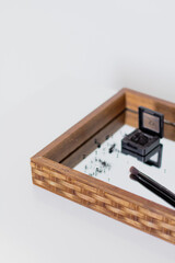 Close up of black makeup cosmetic powder sprinkle on mirror tray. Aesthetic minimalist beauty branding, merchandise concept