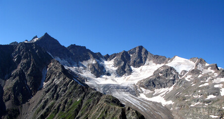 View to Mount Elbrus covered with snow, the highest mountain in Europe, the Caucasus, Kabardino-Balkaria, blue sky and snow covered rocks