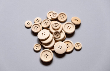 bunch of buttons. wooden buttons on a gray background