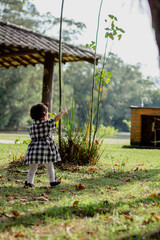 Cute baby girl poiting finger and walking. Aesthetic baby. Child development.