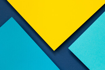 Abstract color papers geometry flat lay composition background with blue and yellow tones. Top view