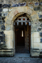 Fototapeta na wymiar Big stone gates of Blandy medieval castle with wooden door