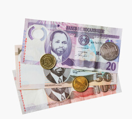 Mozambique banknotes and coins isolated on white.