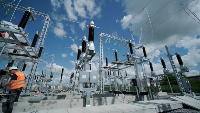 High voltage transformer against the blue sky. Electric current redistribution substation