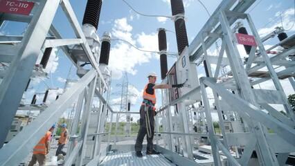 Electrical engineers inspect the electrical systems at the equipment control cabinet