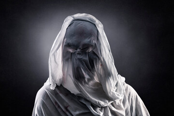 Portrait of a scary ghost over dark misty background