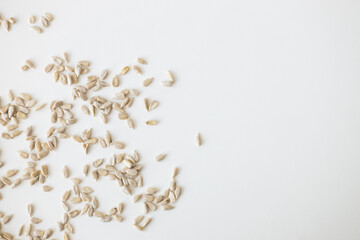Shelled sunflower seeds over white background