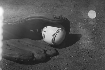 Retro style baseball glove with ball on field close up for game.