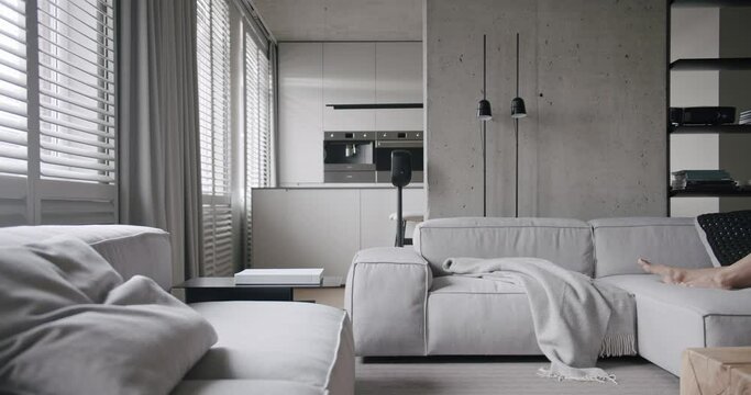 Luxury minimalist design, real apartment with white and gray tones, elegance chair and luxury furniture, white carpet and black audio technica, with concrete, modern kitchen room. Modern living room.