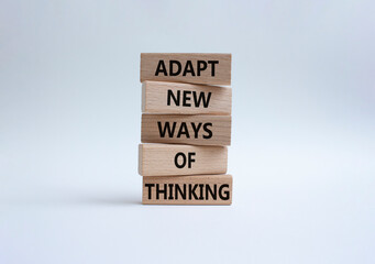 Adapt new ways of thinking symbol. Wooden blocks with words Adapt new ways of thinking. Beautiful white background. Business and Adapt new ways of thinking concept. Copy space.