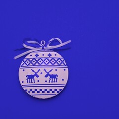 Merry Christmas New Year greeting card with scandinavian ornaments deers. Flat lay white blue christmas minimalist round bauble toy in nordic style over dark blue background