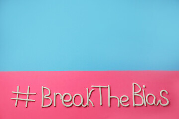 Hashtag BreakTheBias made of modeling clay on color background, top view. Space for text