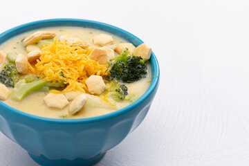 Bowl of Cheddar Cheese and Broccoli Soup on a White Kitchen Counter