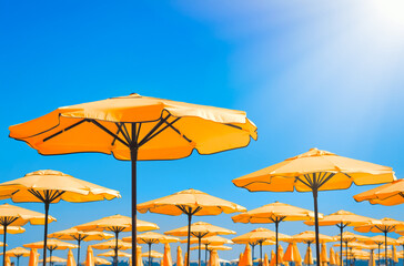 Beautiful orange beach umbrellas against blue sky