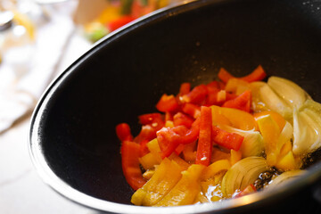 Cooking fresh vegetables in frying pan, closeup