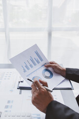 Business Accountant working on desk using calculator for calculate Tax finance expense bookkeeper report in laptop computer Home office