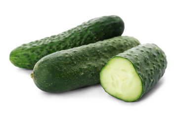 Whole and cut cucumbers on white background