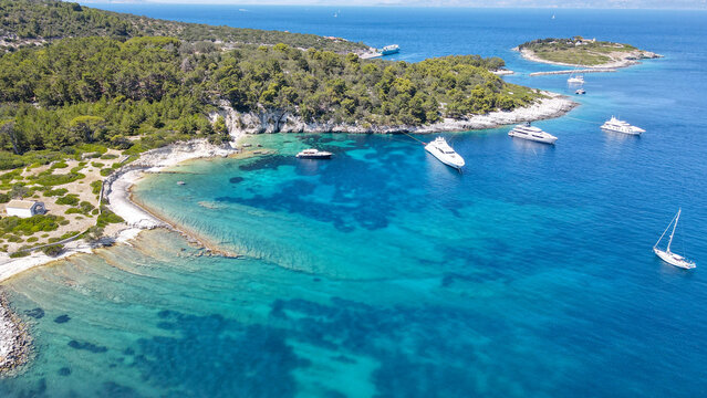 Scenic ionian islands of Greece - Paxos. Aerial drone photo of paradise bay an caves of blue lagoon in beautiful island of Paxos visited by yachts and sail boats, Ionian, Greece