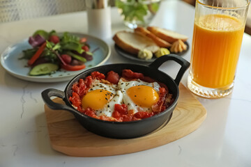 Tasty Shakshouka served on white table. Traditional Arabic dish