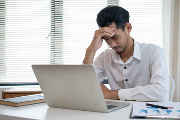 Stressed anxiety businessman nervous and headache because mistake from his job in working office