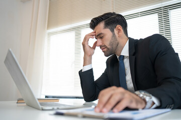 Stressed anxiety businessman nervous and headache because mistake from his job in working office
