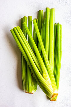 Overhead view of bunches of celery on a table