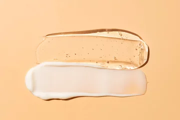 Poster Liquid cream and gel cosmetic smudge drops texture on beige background. cosmetic smears cream texture © IKvyatkovskaya