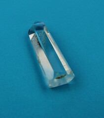 Beautiful Quartz Crystal Point on a Bright Blue Background