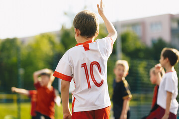 Kids play sports during school physical education training. Elementary age children play sports on...