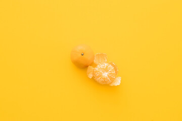 clementine mandarin on a yellow background