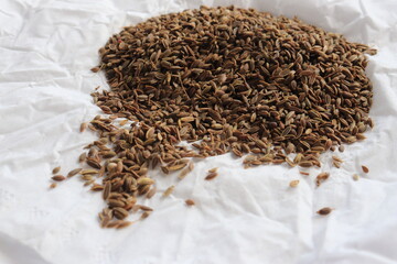 Pile dried of caraway seeds isolated on a white background. Cumin seeds pile isolated on white background. Pile of Carum seeds isolated on white background. Heap of small cumin seeds isolated.