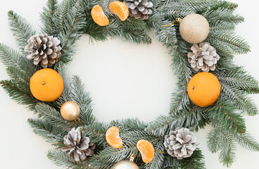 christmas tangerines with fir and cones on a white background