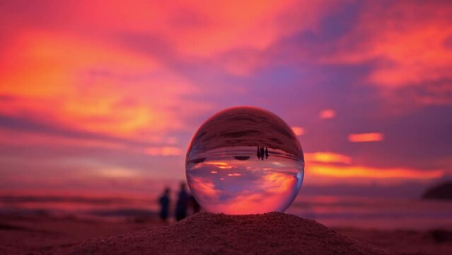 view of beautiful nature at sunset inside crystal ball..stunning sunset over sea in a crystal ball on the beach. .A image for a unique and creative travel..4K Videos for unusual travel ideas