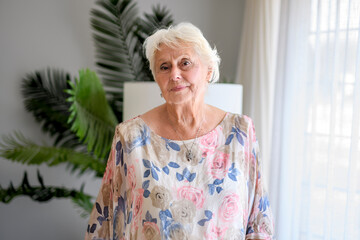 Active beautiful senior woman in the living room.