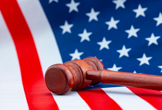 Gavel toppled on American flag displays judicial conflict and fallen justice