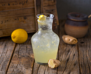 Fresh healthy DAIKI juice with raw fruit served in jar isolated on wooden table side view