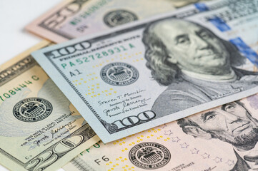 5, 20, 50, 100 dollars banknotes at different angles. Close up of dollars on white background.