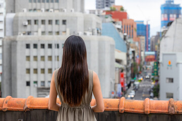 Fototapeta na wymiar Woman look at the city of Taiwan