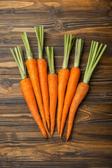 Fresh carrots on brown texture background. Ingredient for salad.Vegetarian organic vegetables.Healthy food.Copy space.Place for text