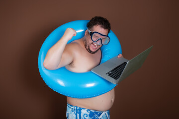 Vacation and holidays. Funny fat man is going to the sea. Guy with an inflatable circle.	