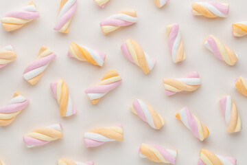 Colorful marshmallows on pastel background.