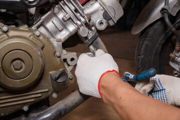 The process of removing the exhaust system from replacing brake pads on a motorcycle.