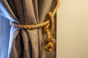  braided rope garter on the curtain close-up. interior detail