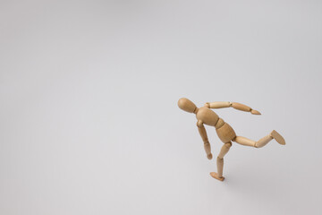 wooden mannequin of a man quickly runs on a white background with copy space