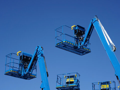 Group Of Aerial Work Platforms For Construction And Material Handling. Close-up To The Basket For Moving People