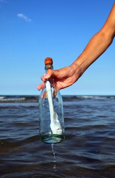 boy who collects the bottle with a secret message at the sea